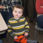 My great nephew Sam is 2 years old. He likes trains. In this picture, he has a tiny chainsaw. . .